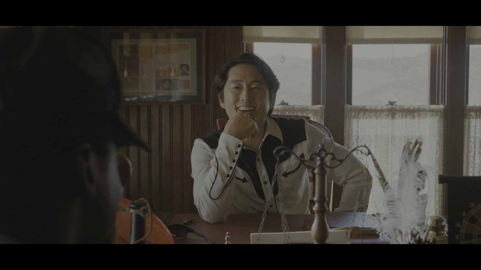 a person sitting at a table with a microphone