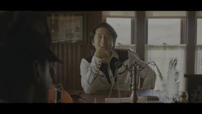a person sitting at a table with a microphone