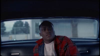 a man sitting in the back of a car