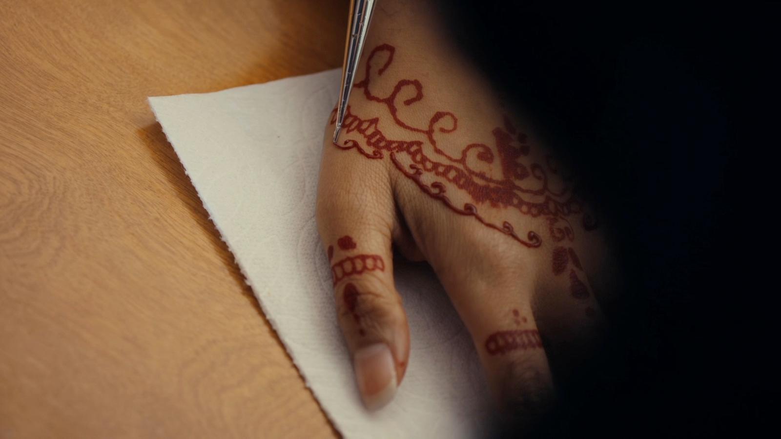 a woman's hand with a henna on it
