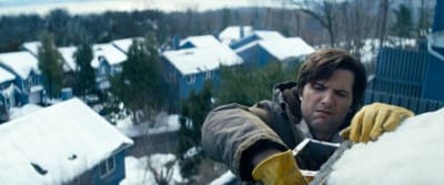 a man in yellow gloves working on a roof