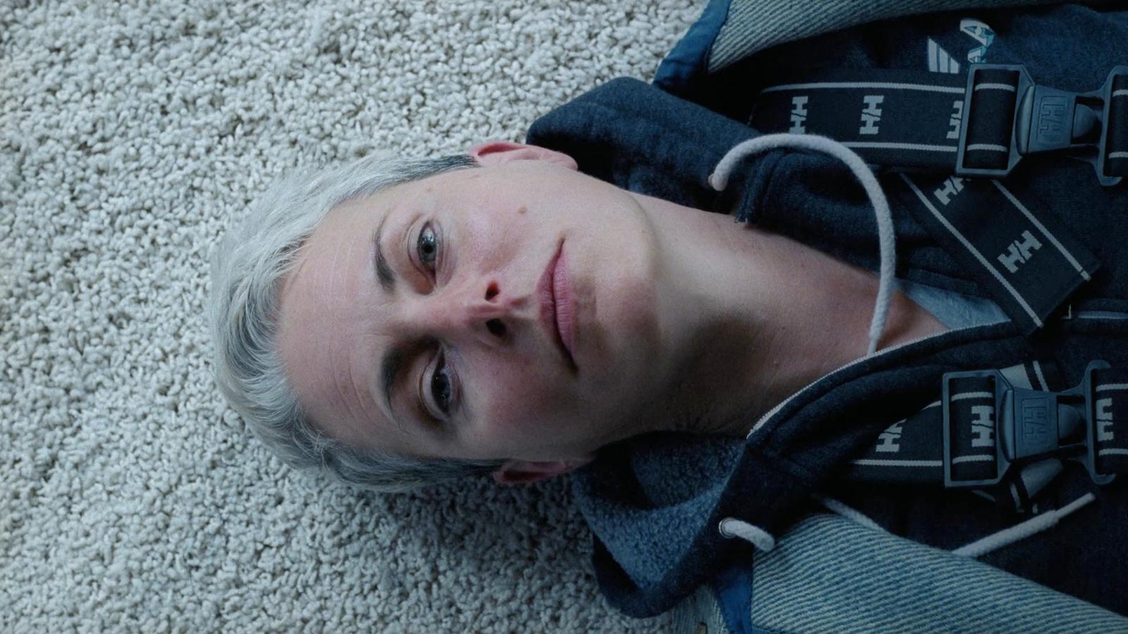 a man laying on the floor with a backpack on his back