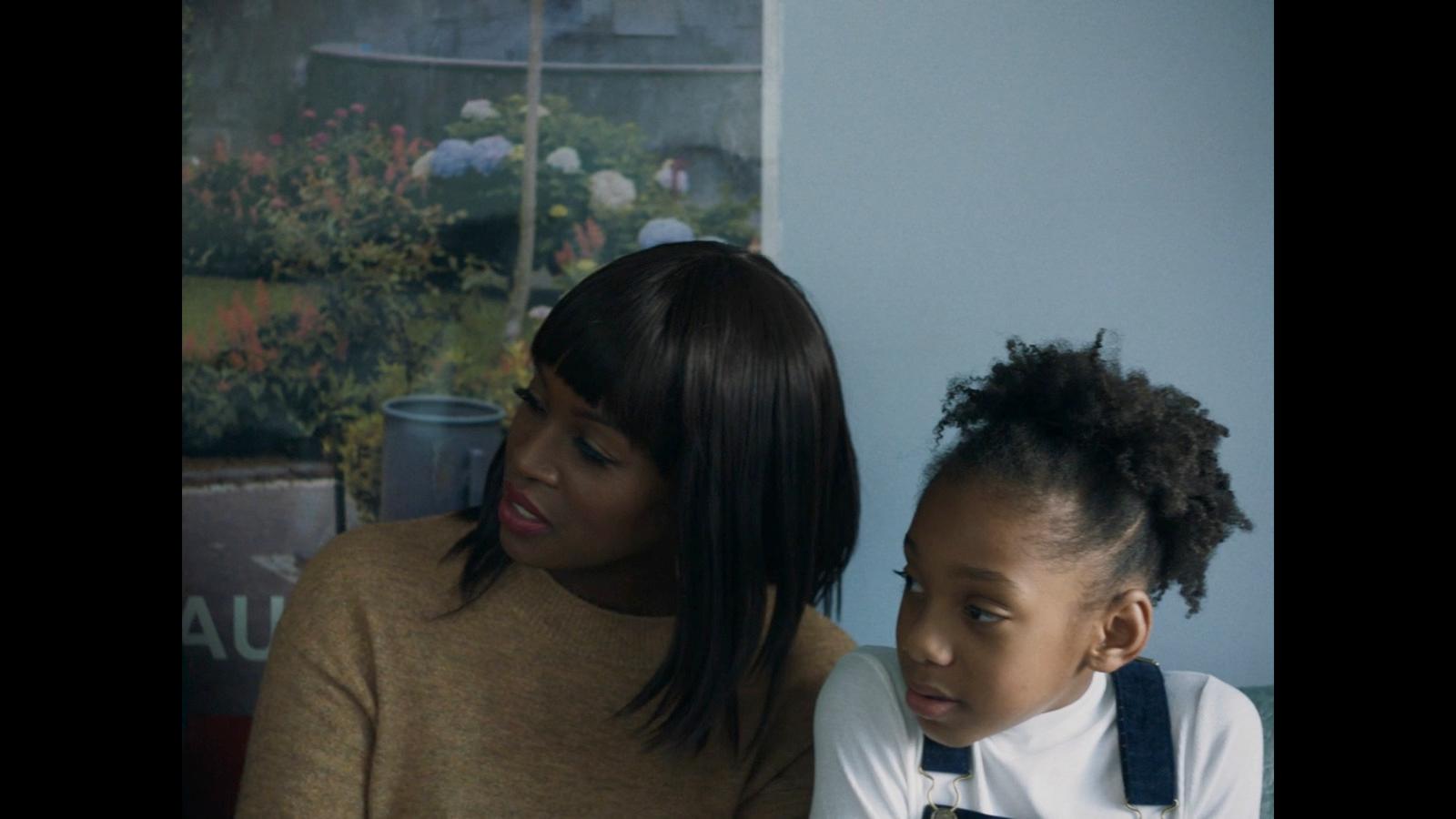a woman and a young girl sitting next to each other