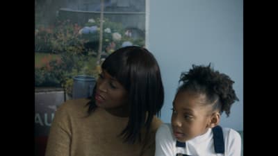 a woman and a young girl sitting next to each other