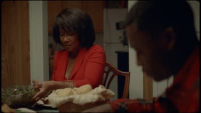 a woman sitting at a table with a bowl of food