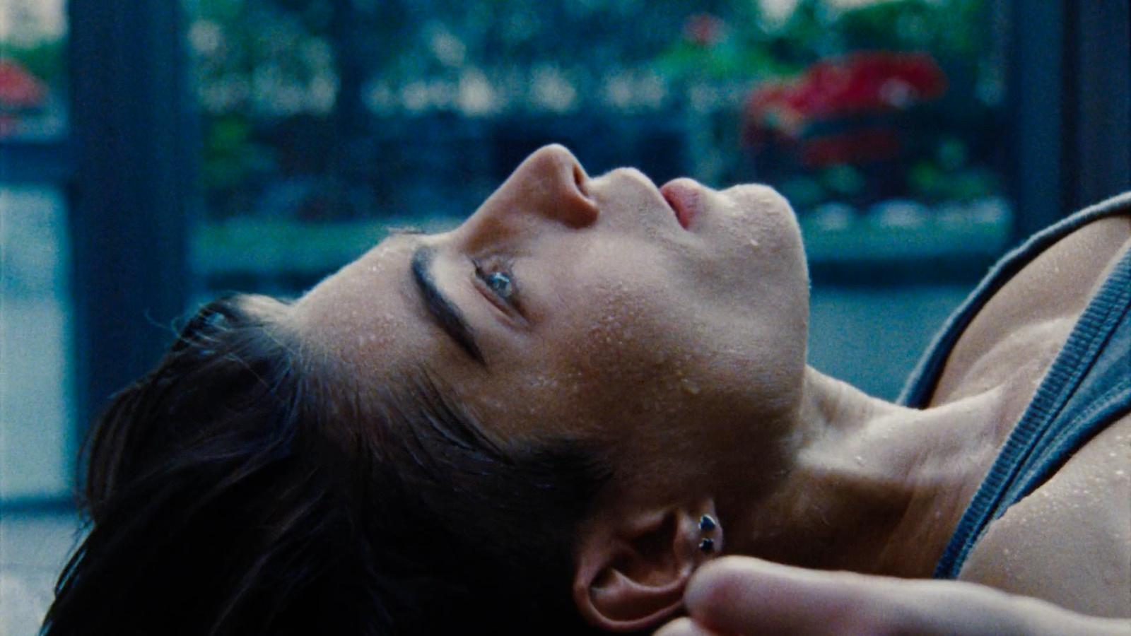 a woman laying on the ground with her eyes closed