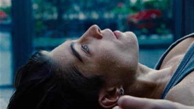 a woman laying on the ground with her eyes closed