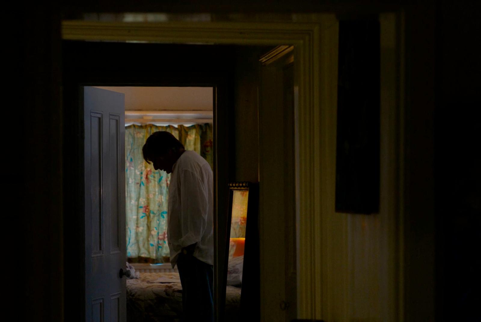 a man standing in a doorway of a house