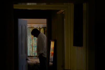 a man standing in a doorway of a house