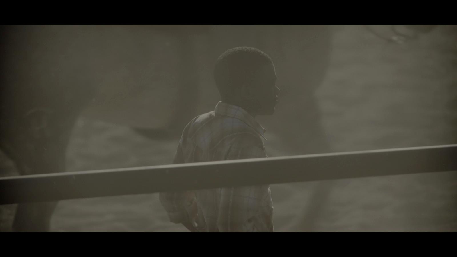 a person standing in front of a fence