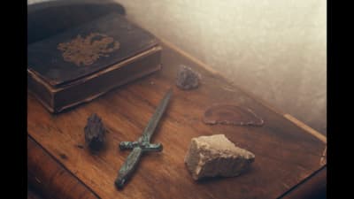 a sword and a rock on a table