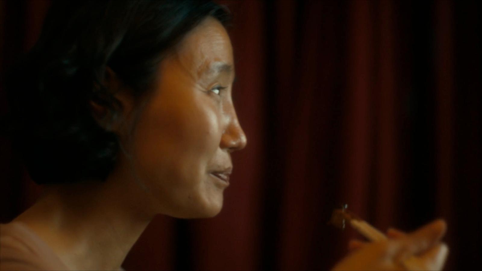 a woman holding a piece of food in her hand