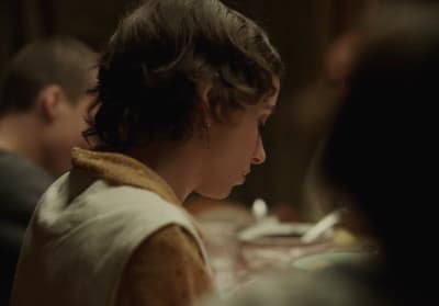 a woman sitting at a table with a plate of food