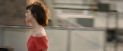 a blurry photo of a woman in a red dress