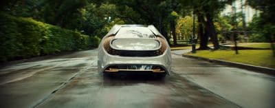 a white car driving down a wet road
