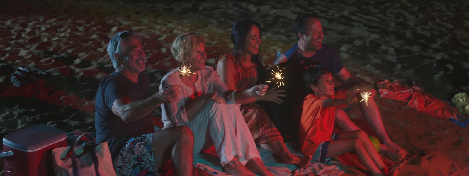 a group of people standing next to each other holding sparklers