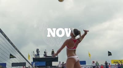 a woman in a bikini playing a game of volleyball