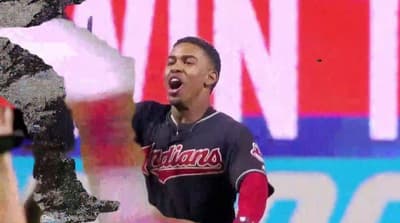 a baseball player holding a bat in his right hand