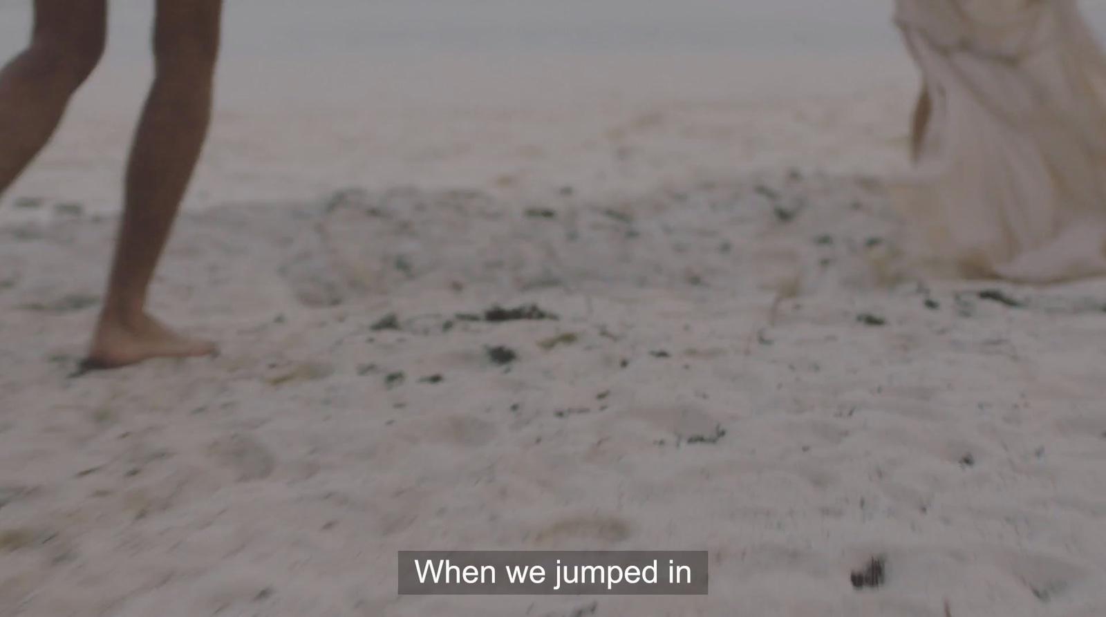 a person walking on a beach with a dress on