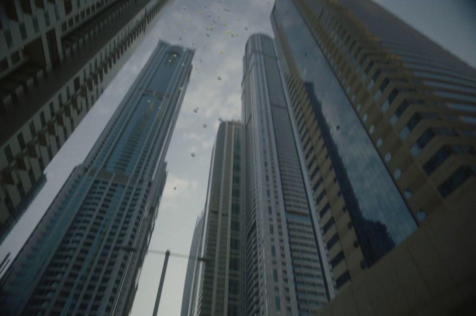 a couple of tall buildings sitting next to each other