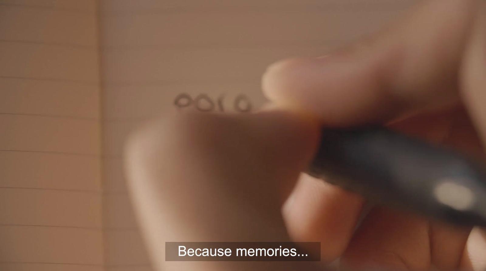 a close up of a person writing on a piece of paper