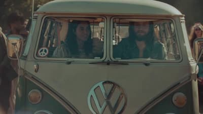 a vw bus with two people in it
