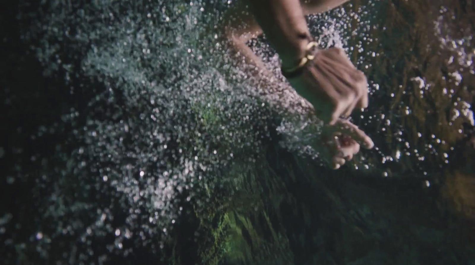 a person standing on a wave in the ocean