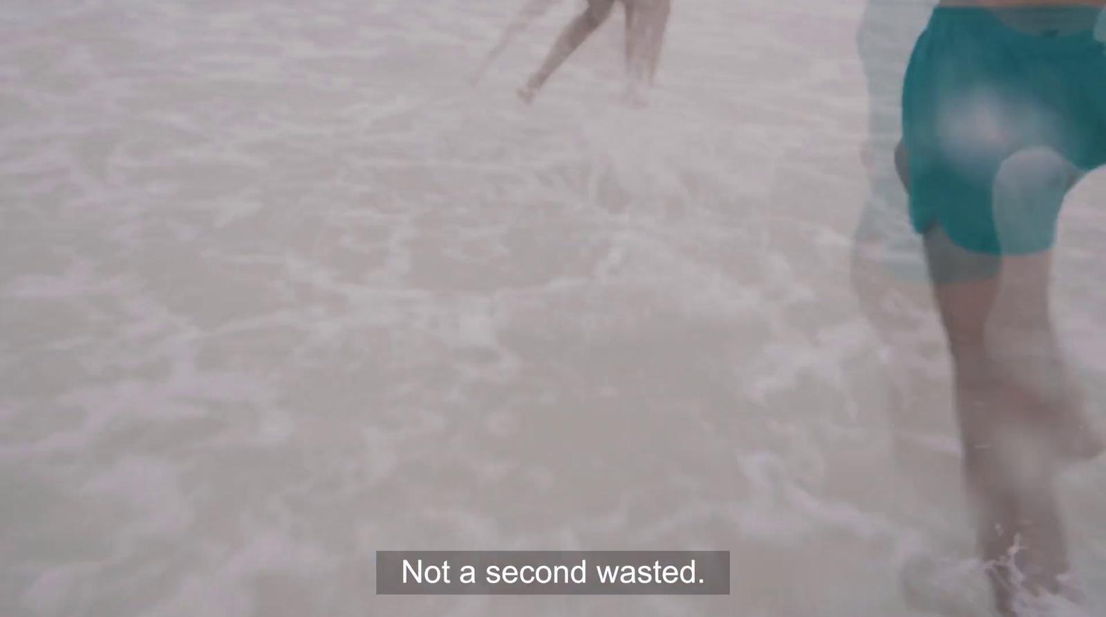 a person standing in the water with a frisbee