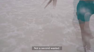 a person standing in the water with a frisbee