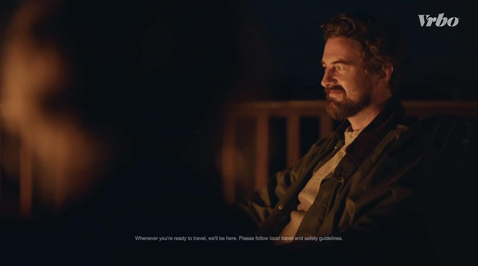 a man sitting in a chair in a dark room