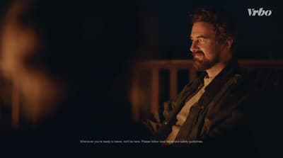 a man sitting in a chair in a dark room
