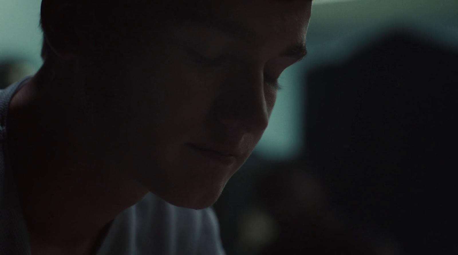 a man looking down at his cell phone