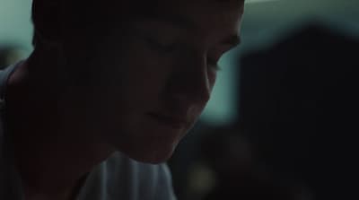 a man looking down at his cell phone