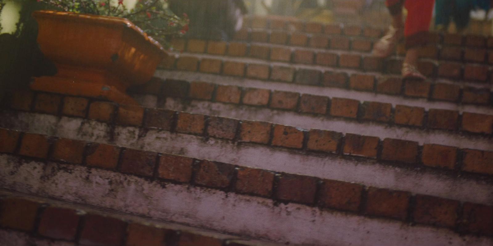 a woman is walking down a set of stairs
