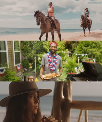 a woman in a hat and a man on a horse on the beach