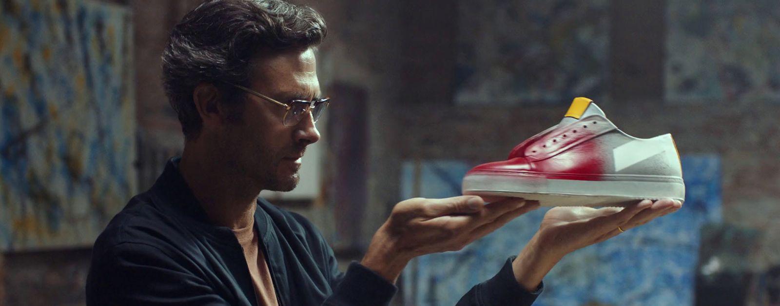 a man holding a shoe in his hand