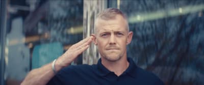 a man holding his hand to his ear