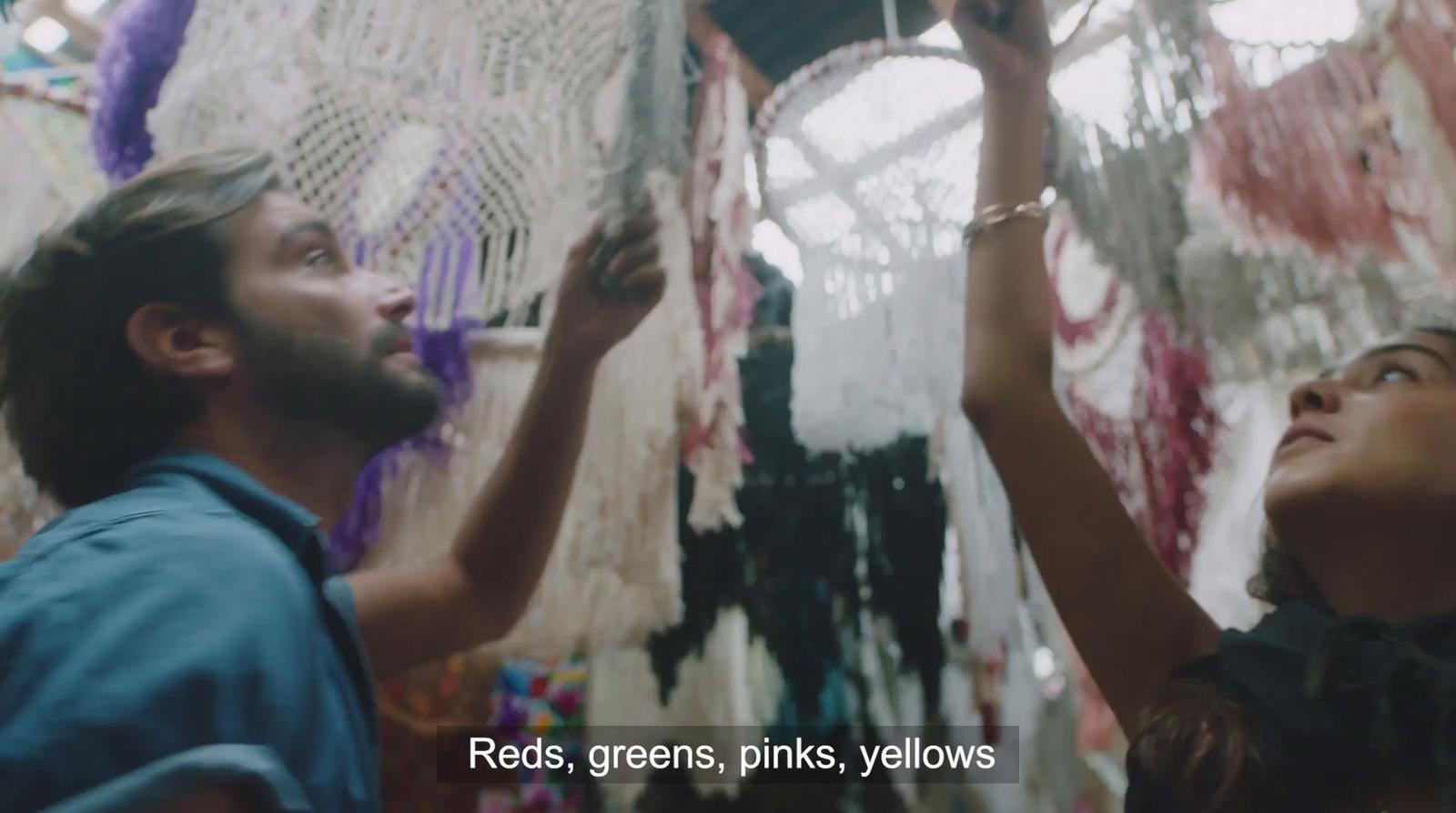 a man and a woman are looking at a macrame
