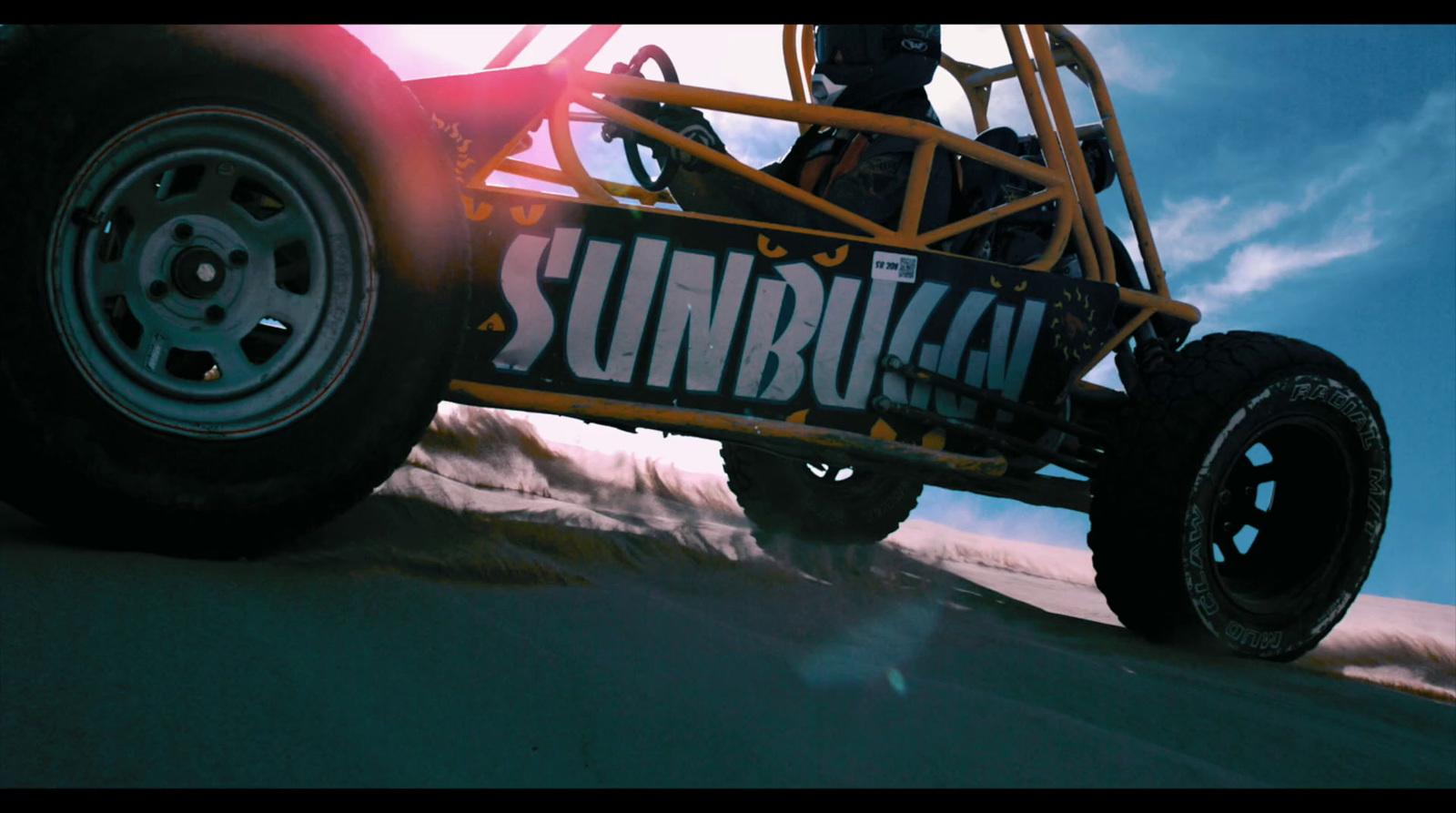 a person riding a dune buggy in the desert