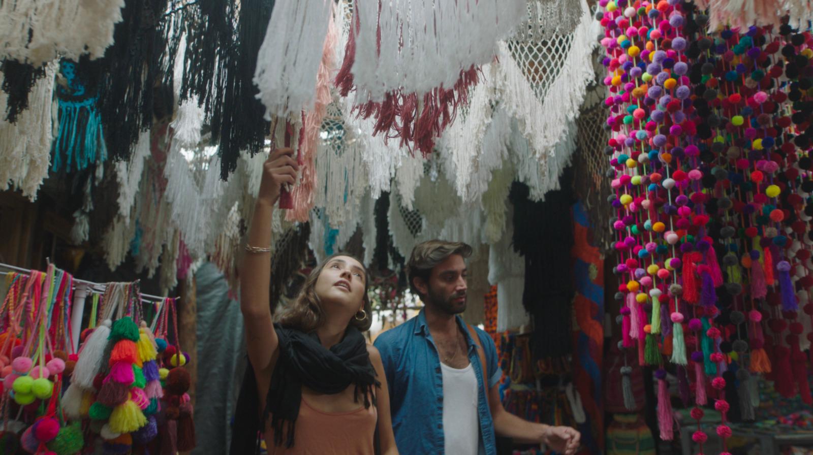 a man and a woman standing in front of a store