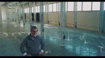 a man is standing in a large room