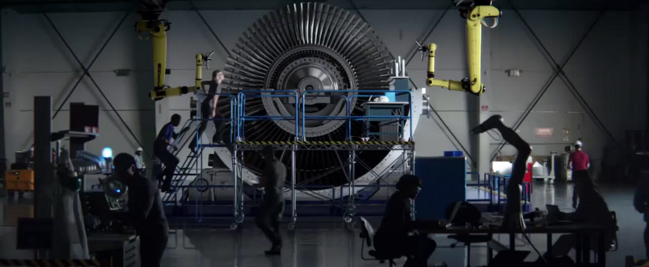 a group of people standing around a machine