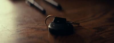 a keychain on a table next to a pair of scissors