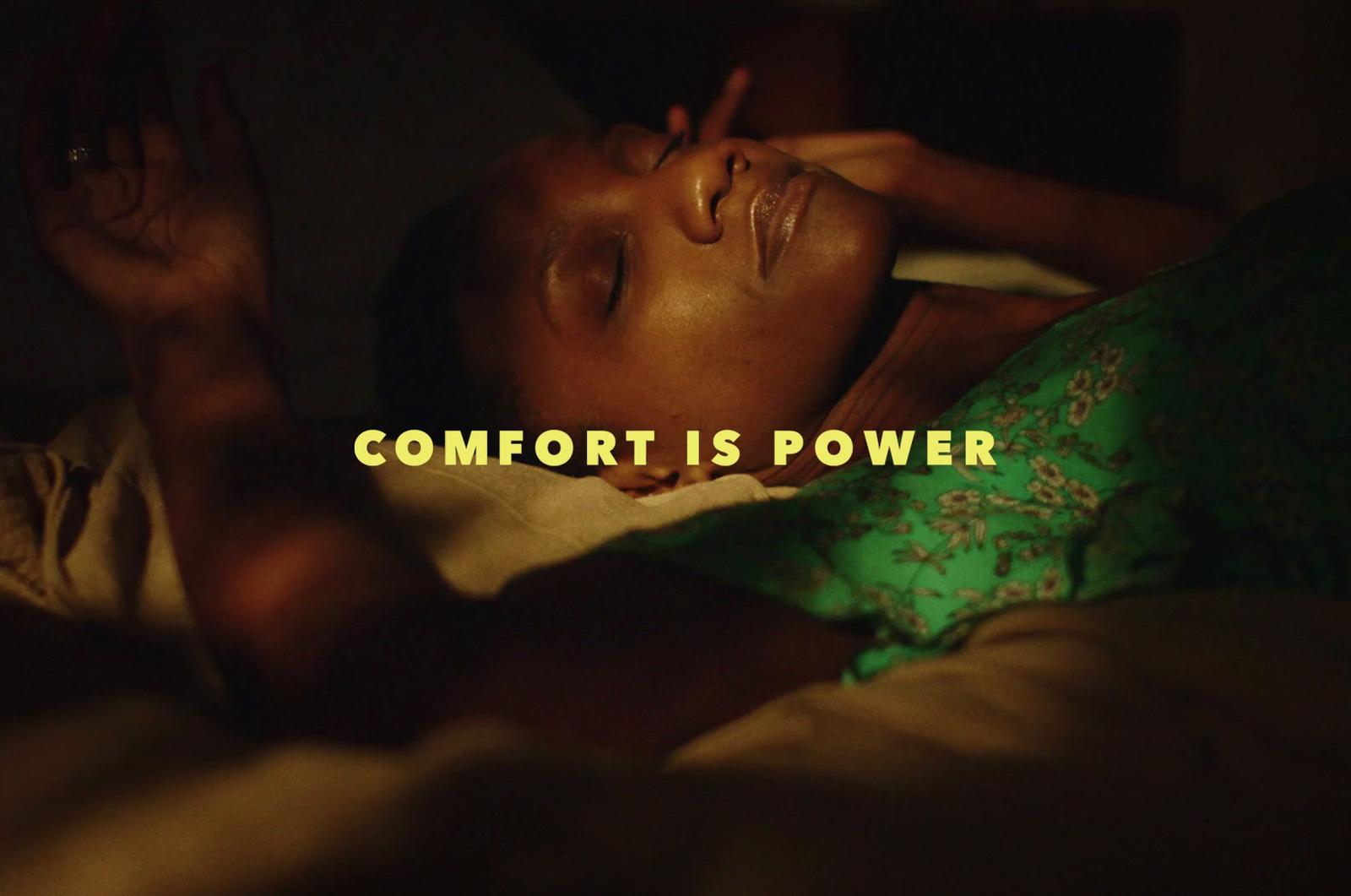 a woman laying in bed with her eyes closed
