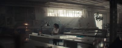 a woman sitting at a desk in a room