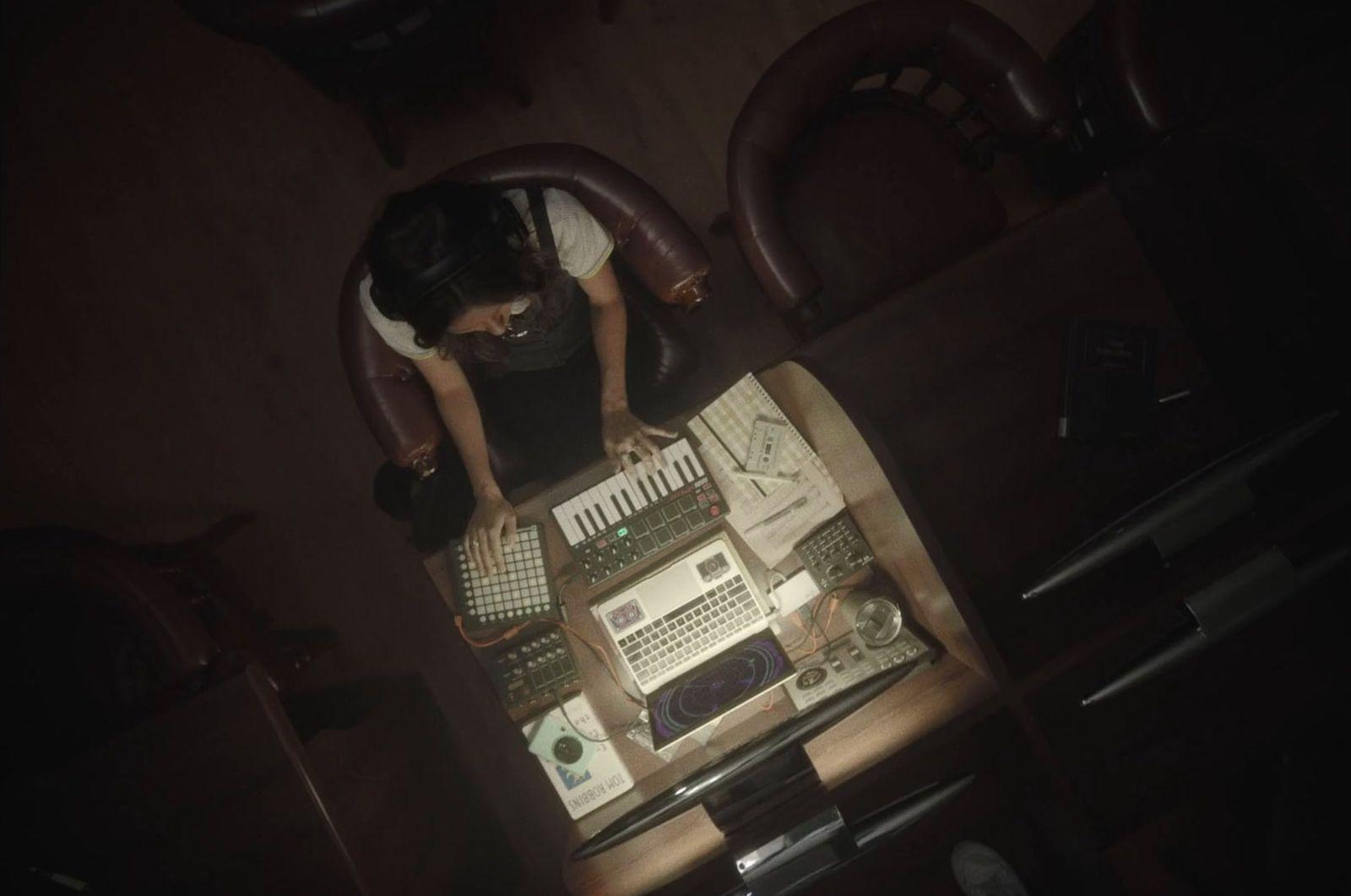 a person sitting at a desk with a keyboard