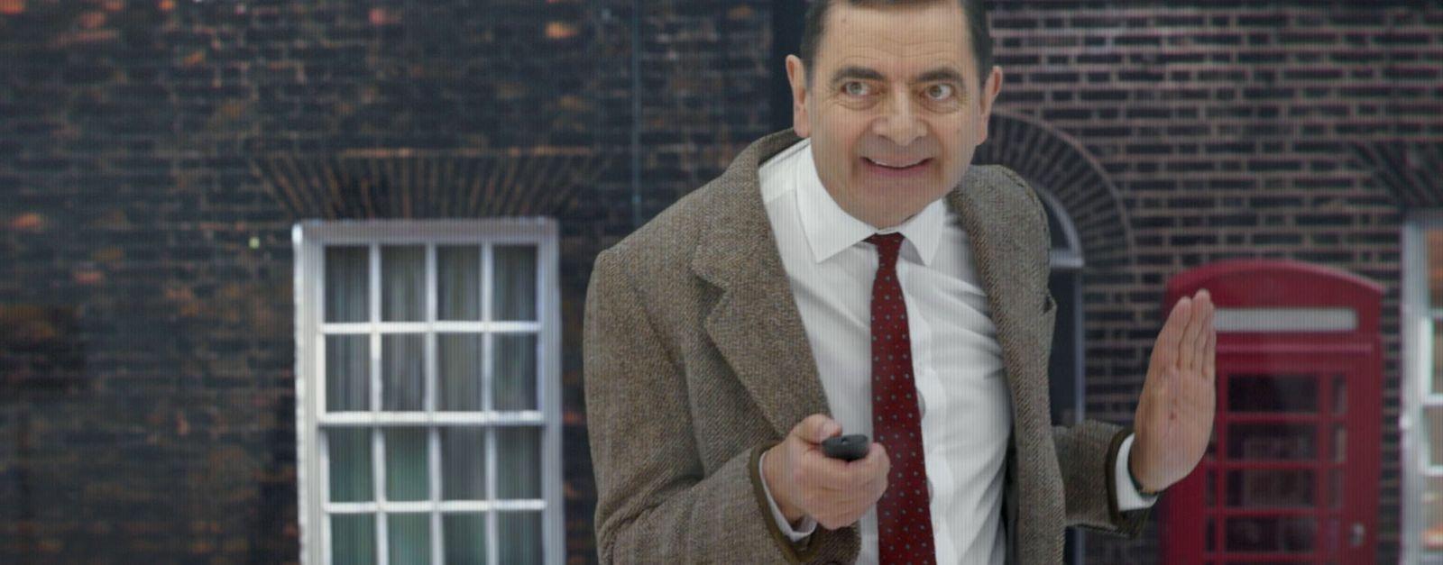 a man in a suit and tie holding a cell phone