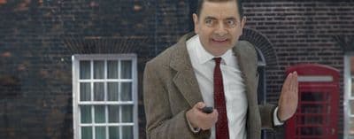 a man in a suit and tie holding a cell phone