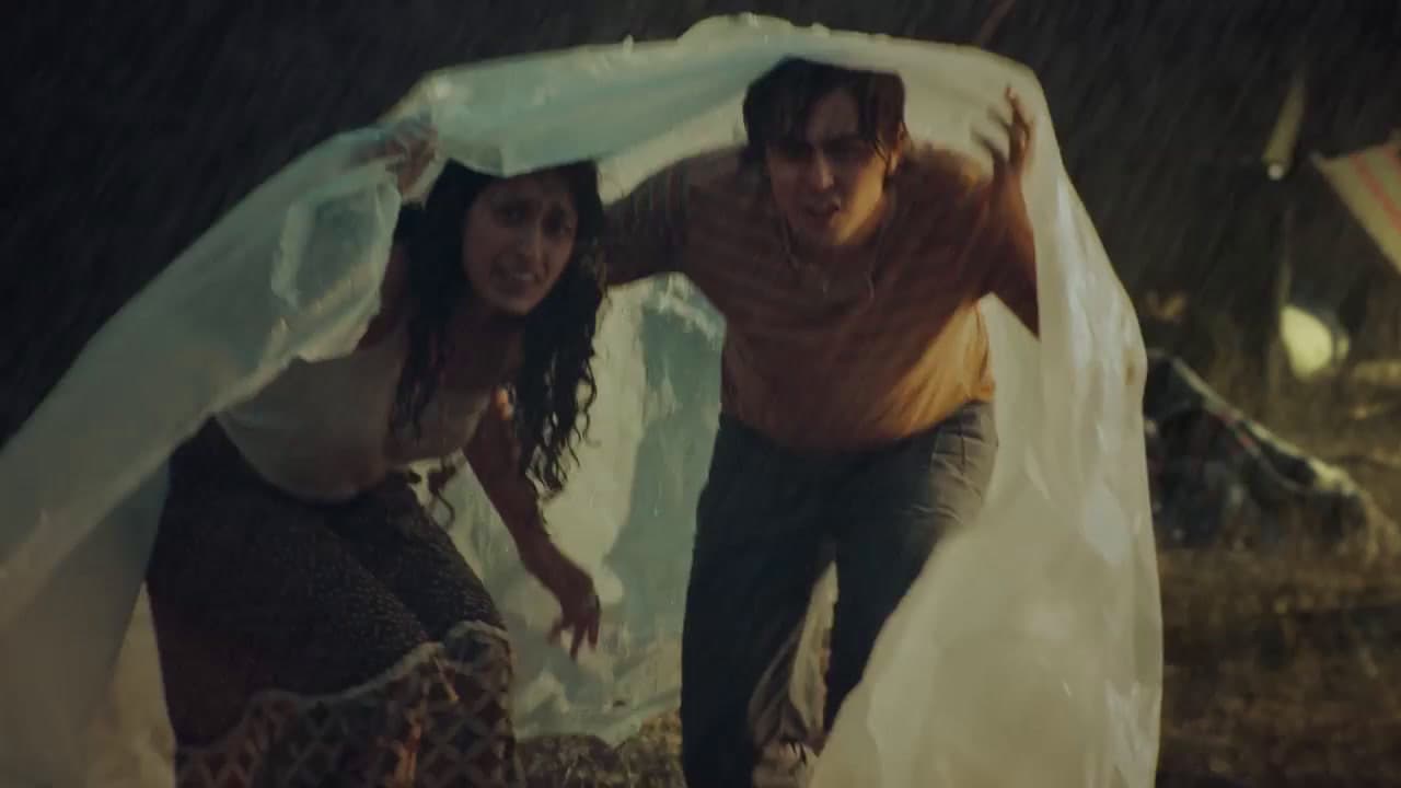 a man and a woman standing in the rain