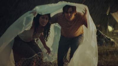 a man and a woman standing in the rain